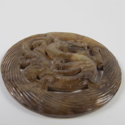 null Asia. China. Spiral Bi disk with dragon. Translucent honey brown nephrite jade....