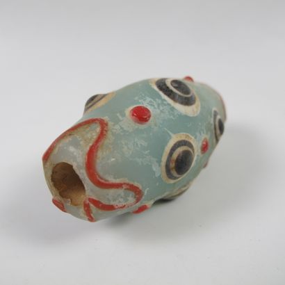null Asia. China. Large tapered bead with 9 symbolic ocelli. Translucent glass paste...