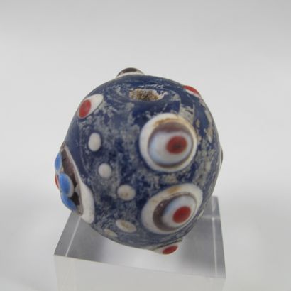 null Asia. China. Large mamelonned bead in a barrel with 6 symbolic ocelli. Glass...