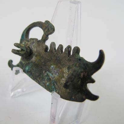 null Fibula representing a Roman galley propelled with an oar to the left. Bronze...