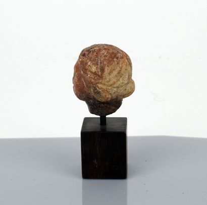 null Head of a young woman wearing an elaborate bun

Red marble 4.7 cm

Roman pe...