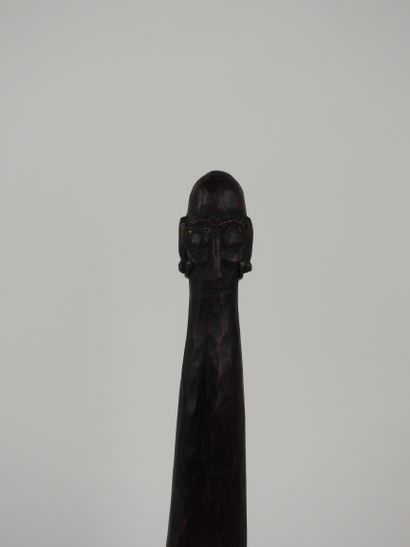 null Bifacial head breaker decorated with a figure of an ancestor.carved wood with...