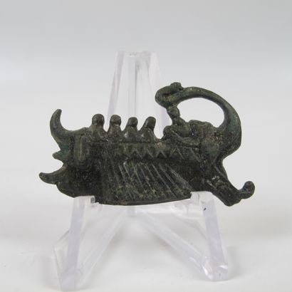 null Fibula representing a Roman galley propelled with an oar to the left. Bronze...
