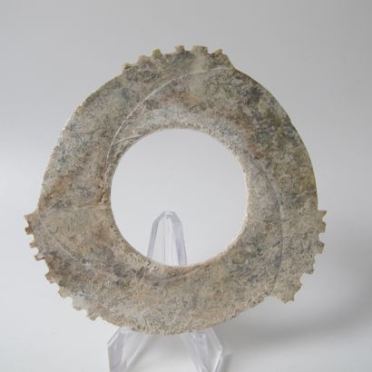 null Fine tridentate jade disc with notched edges, Xuanji. Partially calcified yellow...