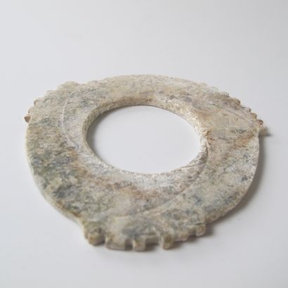 null Fine tridentate jade disc with notched edges, Xuanji. Partially calcified yellow...