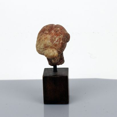 null Head of a young woman wearing an elaborate bun

Red marble 4.7 cm

Roman pe...