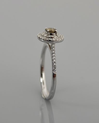 null Round ring in white gold, 750 MM, centered with a round Cognac color diamond...