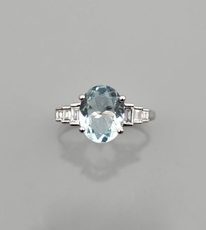null White gold ring, 750 MM, set with an aquamarine weighing 2 carats, with baguette-cut...