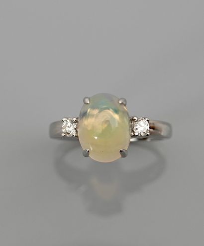 null White gold ring, 750 MM, set with a cabochon opal weighing 1.90 carat between...