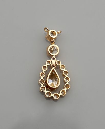 null Yellow gold pendant, 750 MM, set with two round diamonds bearing a mobile pear-cut...