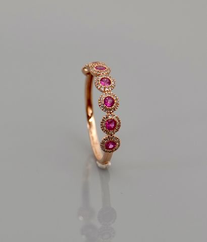 null Half wedding band in pink gold, 750 MM, centered with seven rubies surrounded...
