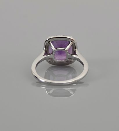 null White gold ring, 750 MM, set with a cushion-cut amethyst hemmed with diamonds,...