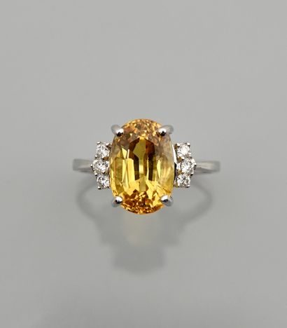 null White gold ring, 750 MM, set with a treated yellow sapphire weighing 5.81 carats...