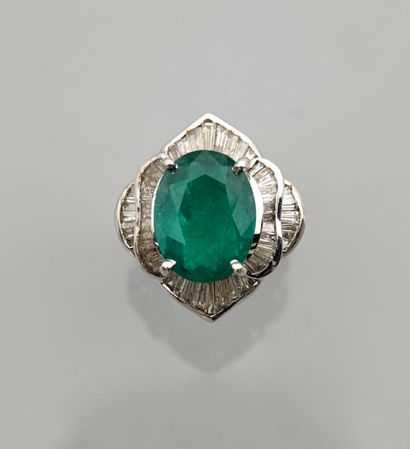 null White gold ring, 750 MM, centered on an oval emerald weighing approximately...