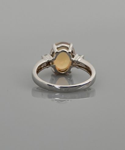 null White gold ring, 750 MM, set with a cabochon opal weighing 1.90 carat between...