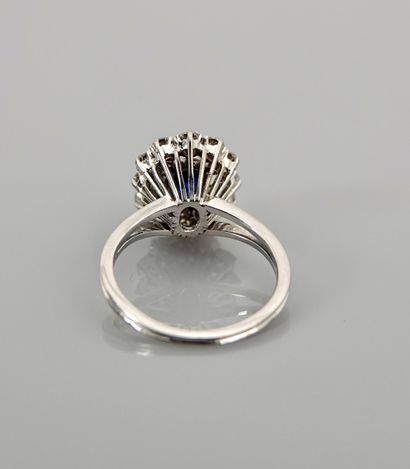 null White gold ring, 750 MM, centered with a sapphire weighing 1.60 carat surrounded...