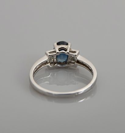 null White gold ring, 750 MM, set with an oval sapphire weighing 1.25 carats, with...