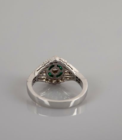 null Ring in white gold, 750 MM, centered on a diamond hemmed with calibrated emeralds...