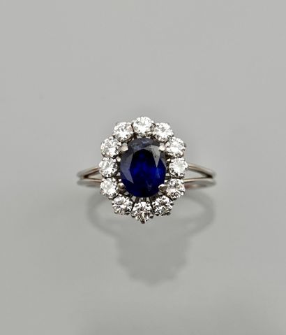 null White gold ring, 750 MM, centered with a sapphire weighing 1.60 carat surrounded...
