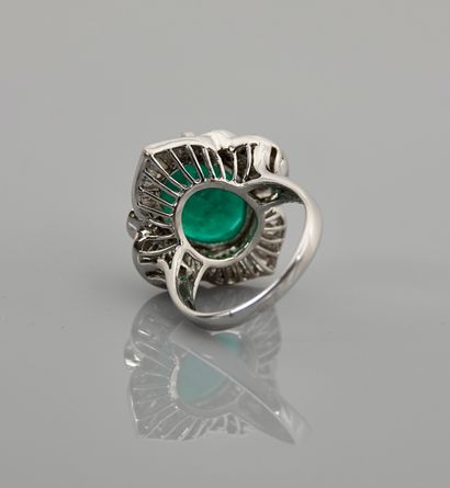 null White gold ring, 750 MM, centered on an oval emerald weighing approximately...