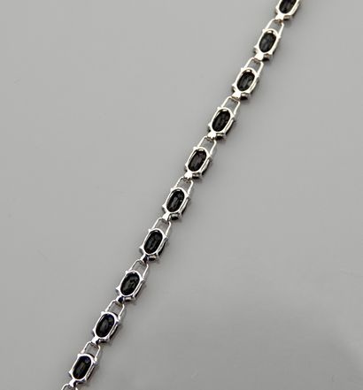null Bracelet line in white gold, 750 MM, highlighted with 24 oval sapphires totaling...