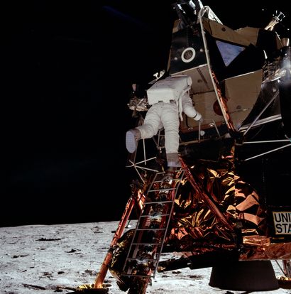 null NASA. LARGE FORMAT. APOLLO 11. Astronaut Buzz Aldrin descends the ladder of...