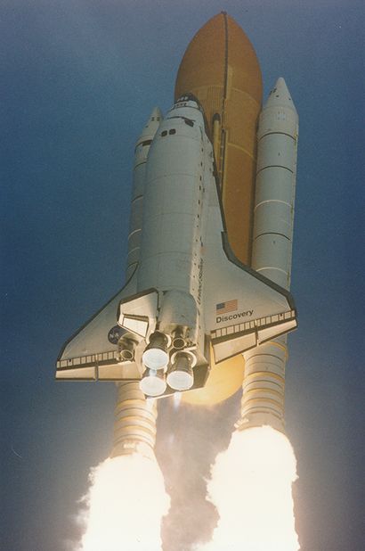 null NASA. Space Shuttle DISCOVERY (Mission STS-96) soars through the morning sky...