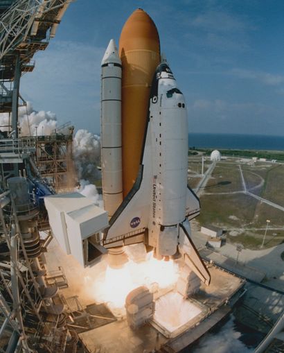 null NASA. Space Shuttle Endeavour blasts off on June 5, 2002, creating wisps of...
