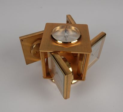 null IMHOF

Gilt brass desk clock with four rotating dials forming a clock, thermometer,...