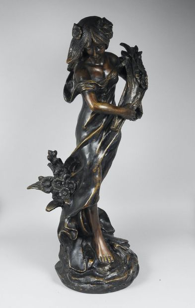 null Large bronze statuette representing a young woman holding a sheaf of flowers,...