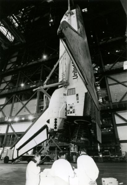 null Nasa. Rare photograph of the space shuttle suspended vertically in its assembly...