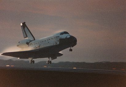 null NASA. As the sun is just setting, Space Shuttle Columbia (Mission STS-80) smoothly...