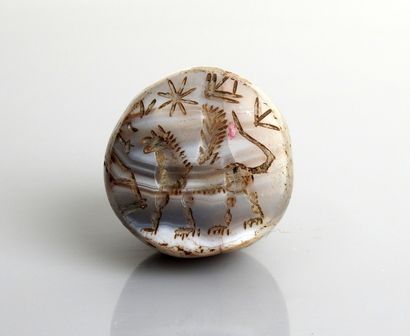 null Hemispheric seal with a winged bull topped by a star

Ancient agate 2.8 cm

Ancient...