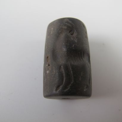 null Three cylinder-seal beads engraved in intaglio with stags, griffins, wolf and...