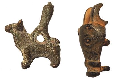 null Amulet in the shape of a bull topped by a phallus and a bull's head applique

Bronze...