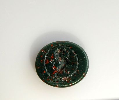 null Intaglio representing a standing lion

Green speckled jasper called heliotrope...