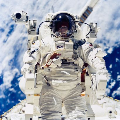 null NASA. Close-up of astronaut Robert L. Stewart appears to hover a few feet above...