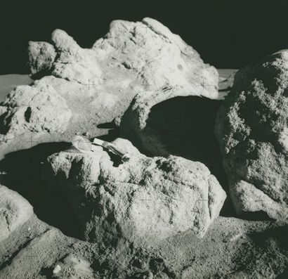 null NASA. Apollo 14. A hammer and a small collection bag are placed on a moon rock...