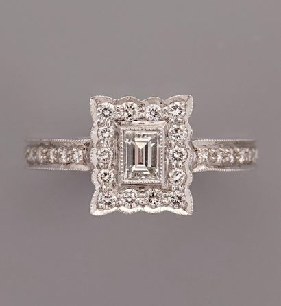 null Rectangular white gold ring, 750 MM, centered with a baguette-cut diamond surrounded...