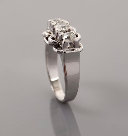 null White gold ring, 750 MM, centered with three very white diamonds between loops...