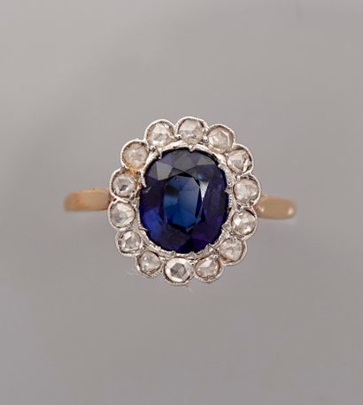 null Fine yellow gold Pompadour ring, 750 MM, centered on an oval blue stone in a...