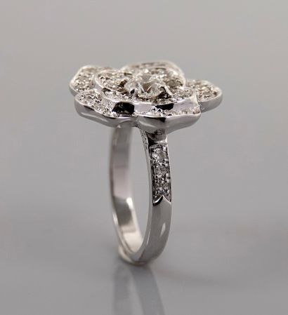 null Flower ring in white gold, 750 MM, centered with a diamond weighing 0.40 carat...