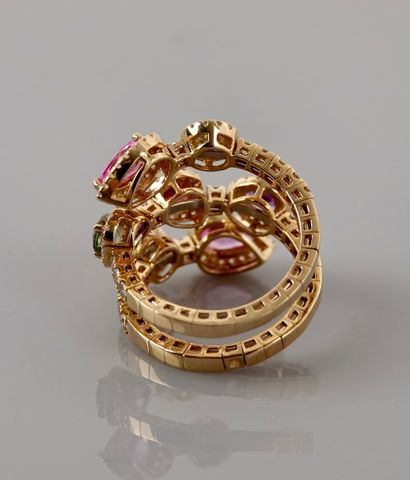 null Ring formed by a ribbon wound in yellow gold, 750 MM, highlighted with diamonds...