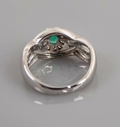 null Ring in white gold, 750 MM, centered on an oval emerald surrounded and shouldered...