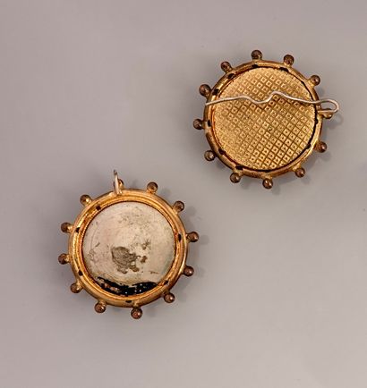 null Pair of round gilt metal elements, one with its clasp on the back, each decorated...