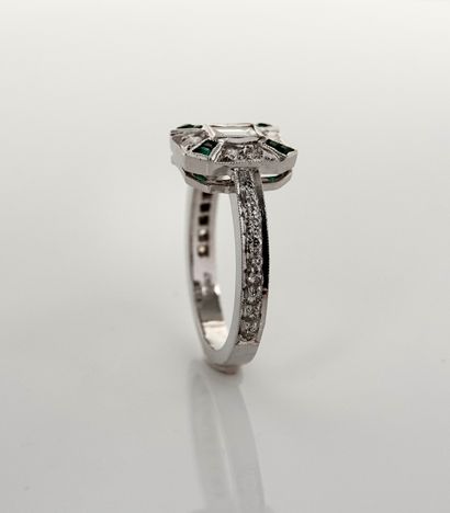 null Ring in white gold, 750 MM, centered on a baguette-cut diamond punctuated by...