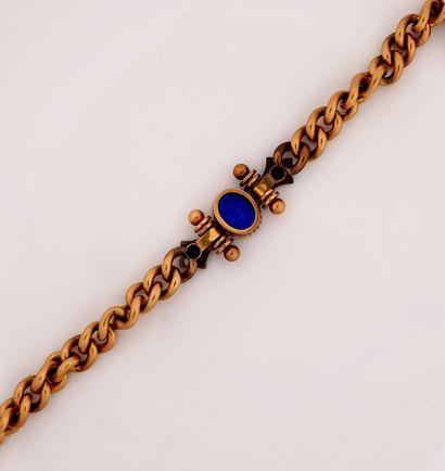 null Yellow gold bracelet, 750 MM, centered with a synthetic blue stone between two...