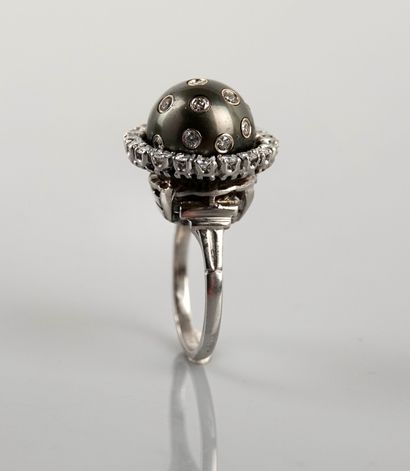 null Ring in white gold, 750 MM, centered with a Tahitian pearl encrusted with nine...