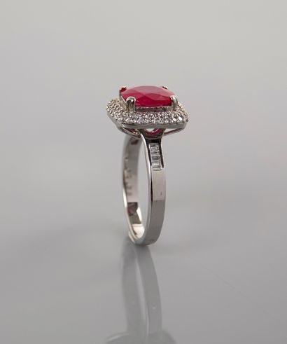 null Ring in white gold, 750 MM, set with an oval ruby weighing 2.37 carats surrounded...