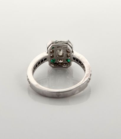 null Ring in white gold, 750 MM, centered on a baguette-cut diamond punctuated by...